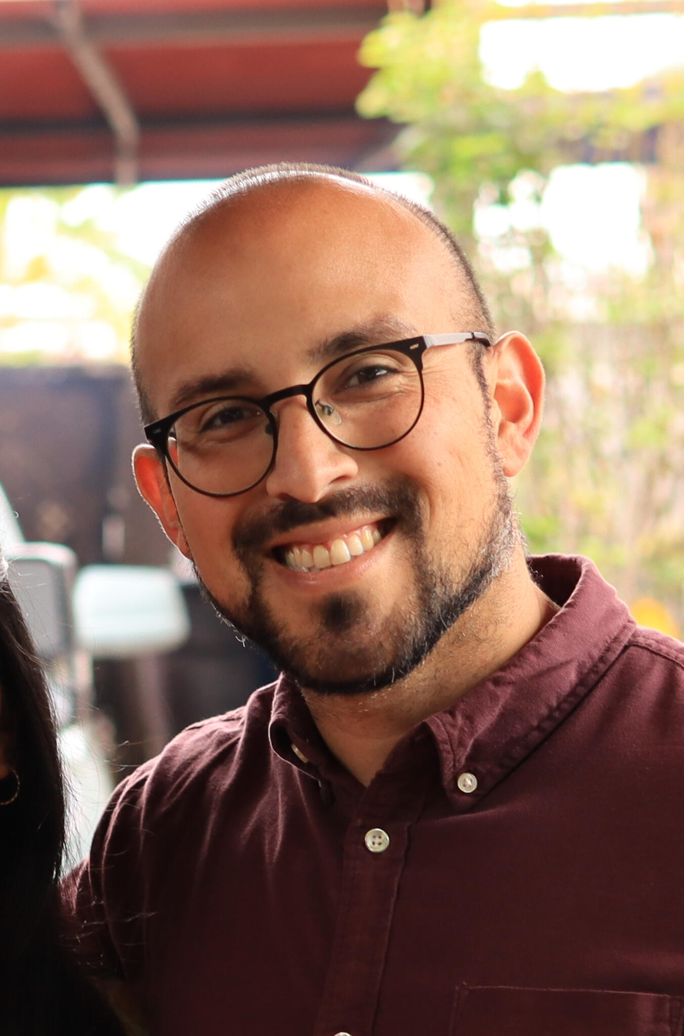 Founder A headshot photograph of the founder, Michael Cuellar, smiling outside.