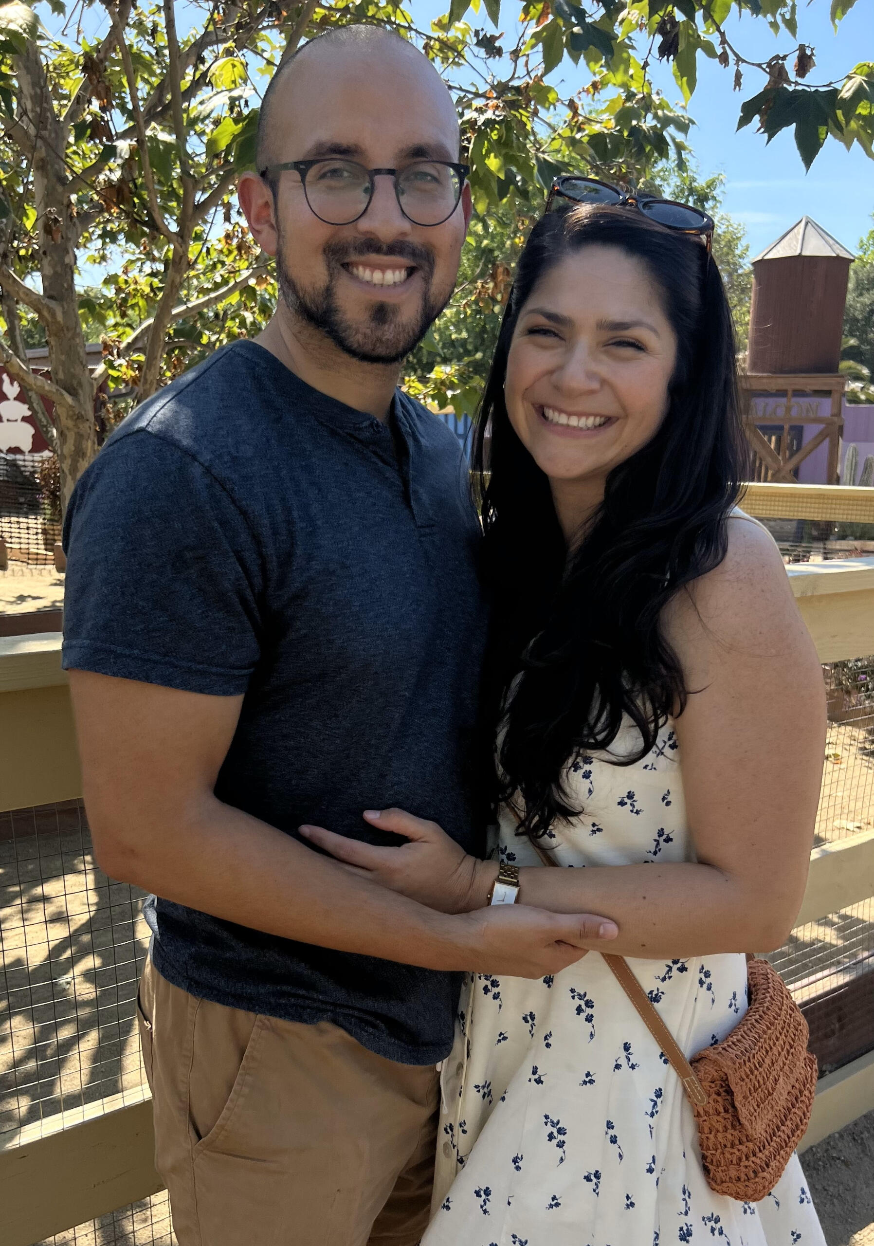 Founder' Wife A photograph of the founder, Michael Cuellar, smiling together under the shade of a tree.